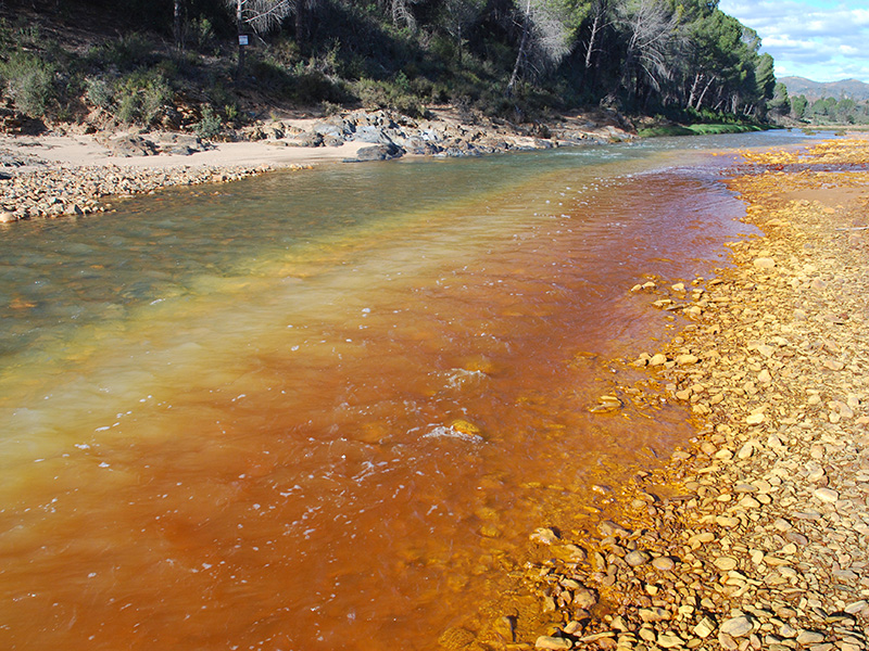 Mixing of acidic mine drainage into Rio Odiel, Spain.