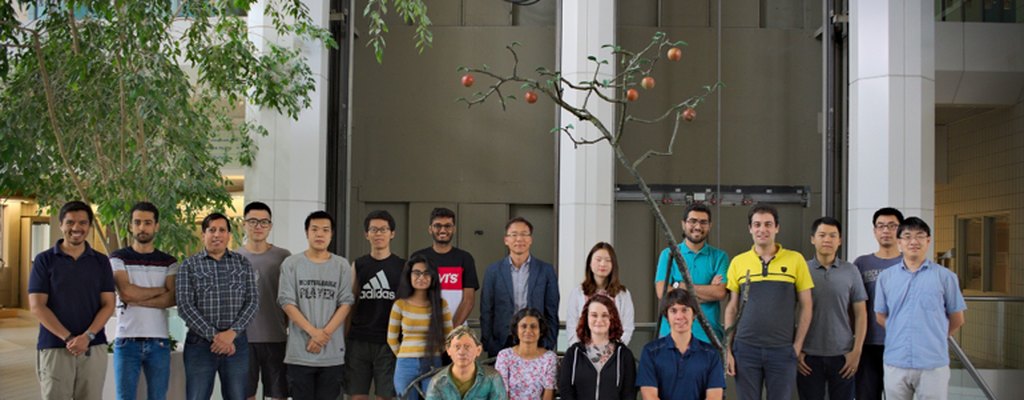 Members of the Ko Lab standing together in a campus atrium at the University of Saskatchewan.