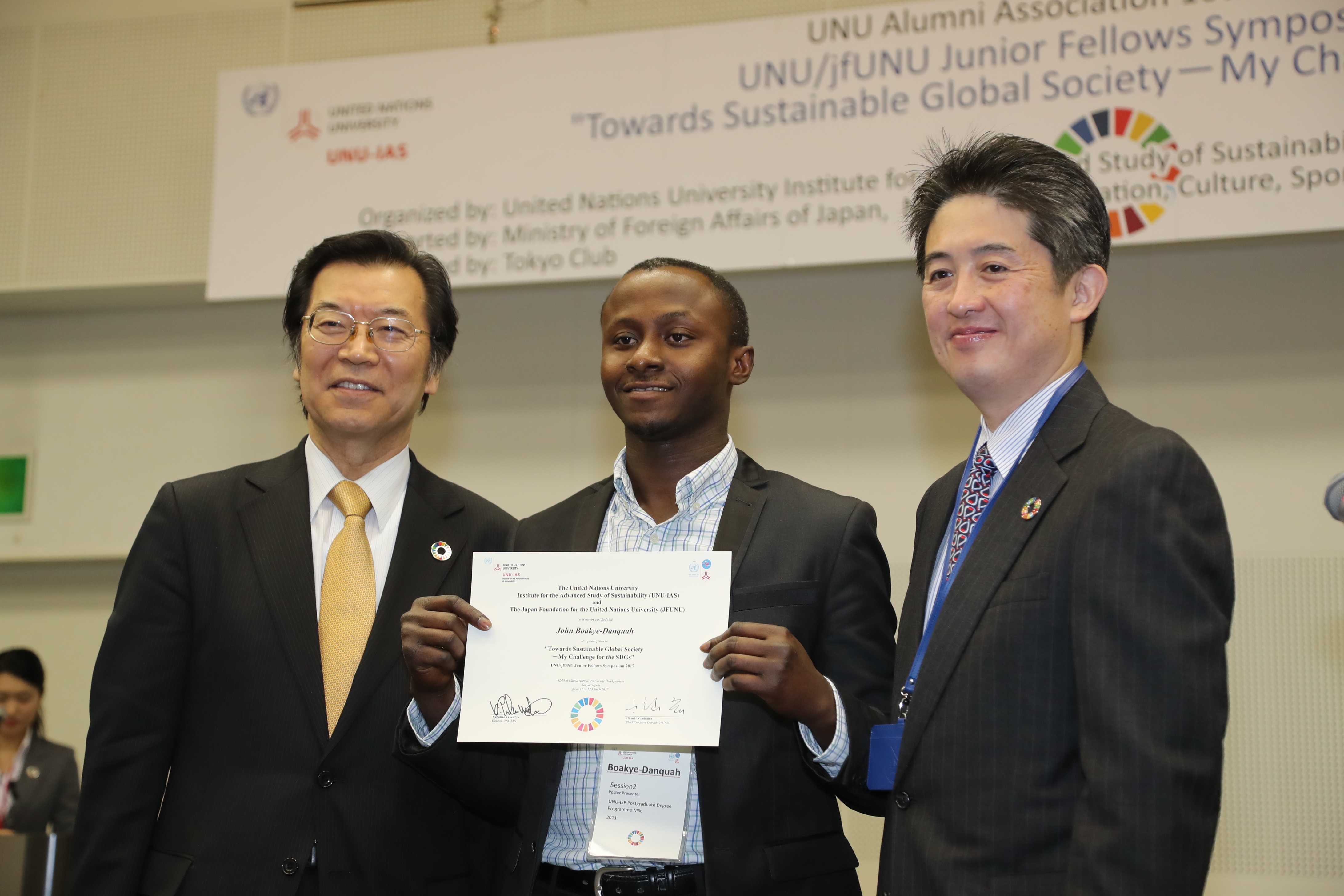 John showing a certificate of participation at the UNU Alumni symposium
